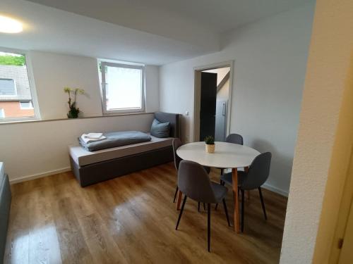 a living room with a table and a couch at ND Hotels & Apartments Bottrop am Centro in Bottrop