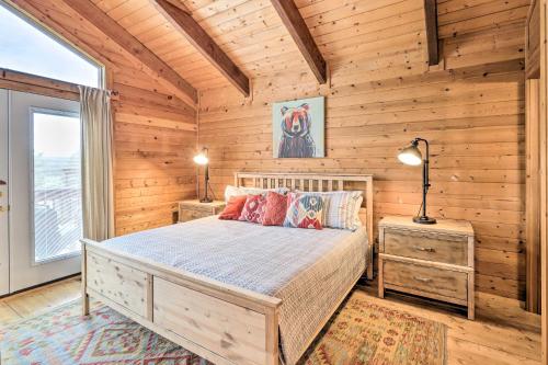 una camera da letto con un letto in una stanza di legno di Luxe Pagosa Springs Cabin with Sauna and Hot Tub! a Pagosa Springs