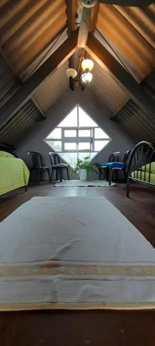 a large room with a large bed and a window at Casa Grande Retiro para grupos in Cerro Azul