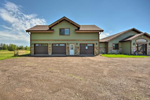 a large house with two garage doors on a driveway at Duluth Studio with Sauna on Working Horse Farm! in Duluth