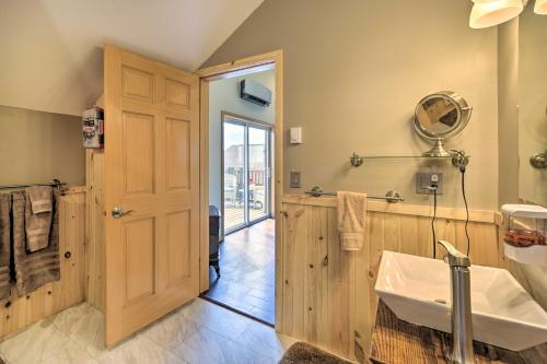 a large bathroom with a sink and a mirror at Duluth Studio with Sauna on Working Horse Farm! in Duluth