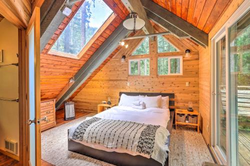 a bedroom in a tree house with a bed in it at Peaceful Wooded Cabin By Mt. Baker Ski Area! in Glacier