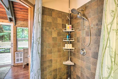 a bathroom with a shower with a shower curtain at Peaceful Wooded Cabin By Mt. Baker Ski Area! in Glacier