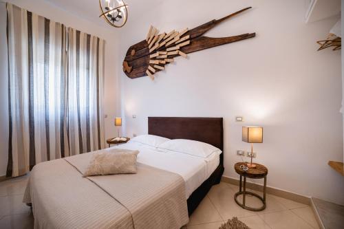 a hotel room with a bed and a fish on the wall at Love & Fama Hotel in Sabaudia