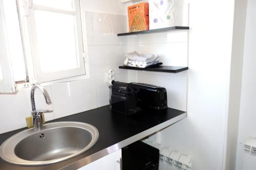 a bathroom with a sink and a microwave on a counter at Design Picasso workshop 1900 in Paris