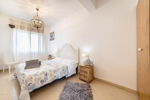 a bedroom with a bed and a table and a window at Love & Fama Hotel in Sabaudia