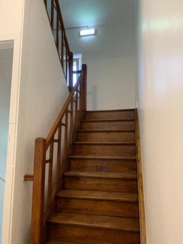 a stairway with wooden stairs in a building at Nice rooms in Beggen house - In Luxembourg city in Luxembourg
