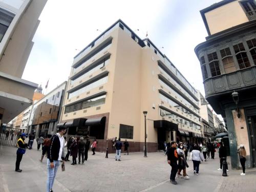 a group of people walking around in a street at Hotel MAURY in Lima