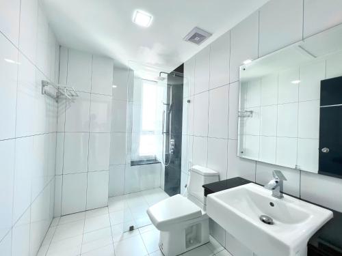 a white bathroom with a sink and a toilet at PTH Residence in Phnom Penh