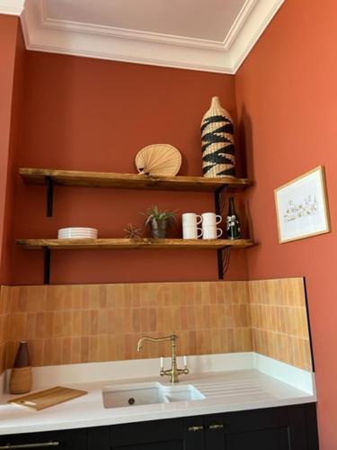 a kitchen with a sink and shelves on the wall at Field Maple -free parking -Grade II listed- first floor two bedrooms apartment in Huntingdon