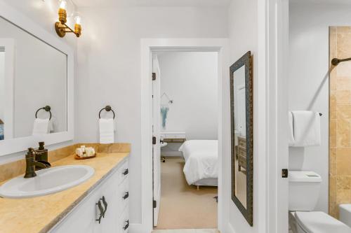 a bathroom with a sink and a mirror at Koolkondo Luxury Designer Condo in Koloa