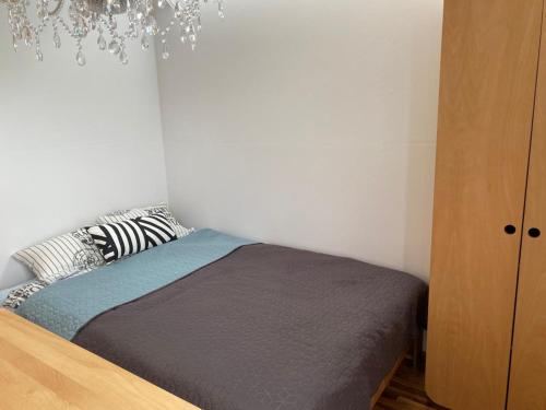 a bedroom with a bed and a chandelier at EcoRelax in Błotnik