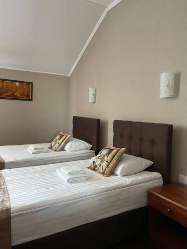 two beds in a room next to each other at Zatyshok in Vinnytsya