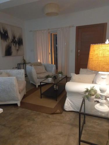 a living room with a bed and a couch and a table at Cabarete Kite Beach Rooms & Condos in Cabarete