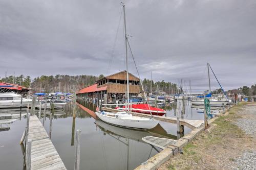 a boat is docked at a dock with other boats at Walk to Marina Cute Gilford Cottage with Grill in Gilford