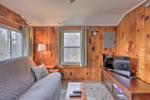 a living room with a couch and a tv at Walk to Marina Cute Gilford Cottage with Grill in Gilford