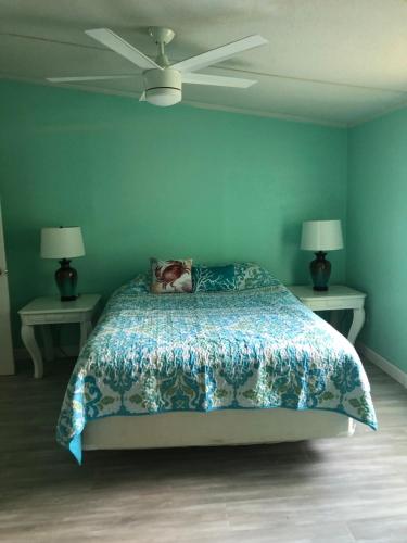 a bedroom with a bed and two tables with lamps at Quiet Gateway close to the Marina, Beach and Base in Sneads Ferry