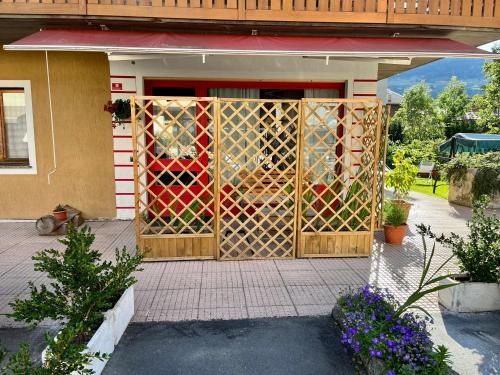 a door with a fence in front of a house at Neve monolocale, ottima posizione, posto auto. in Bormio