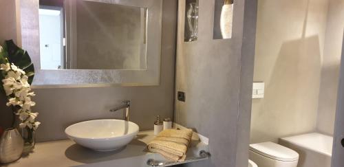a bathroom with a white sink and a toilet at Il Vascello in Rapallo