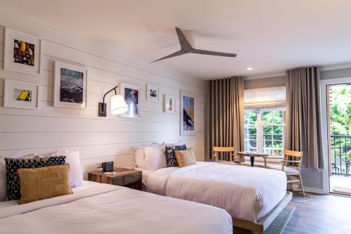 a hotel room with two beds and a window at Boarding House Cape May in Cape May