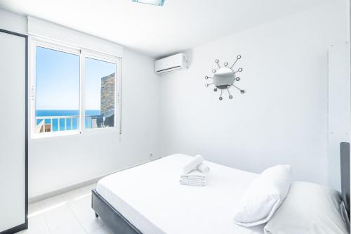 a white room with a bed and a window at Penthouse Bella Vista in Benidorm