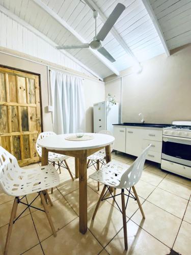 a kitchen with a table and chairs in a room at Cayetana in Puerto Iguazú