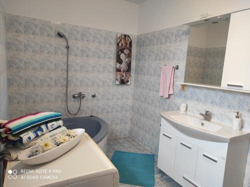 a bathroom with a sink and a toilet and a tub at Home of nature - kuća prirode in Odžak