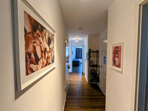 a hallway of a home with a painting on the wall at Leipzig-Residenz Waldstraße am Zoo und Red Bull Arena , Rooftop Apartment mit 2 Dachterrassen in Leipzig