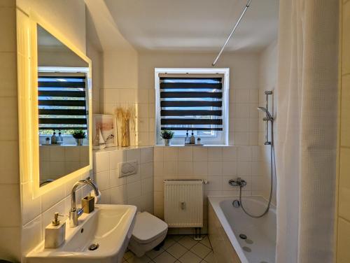 a bathroom with a tub and a sink and a toilet at Leipzig-Residenz Waldstraße am Zoo und Red Bull Arena , Rooftop Apartment mit 2 Dachterrassen in Leipzig