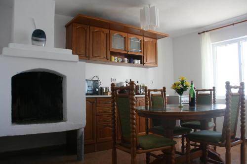 cocina con chimenea y mesa con sillas en Villa Sanaan, en Bryastovets