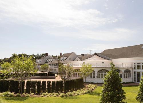 an exterior view of a large white house at Canoe Place Inn & Cottages in Hampton Bays