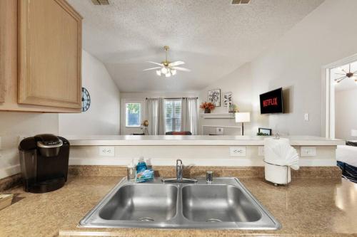a kitchen with a sink and a counter at *The Hideaway* NFLX/Arcade/Soak tub in Burleson