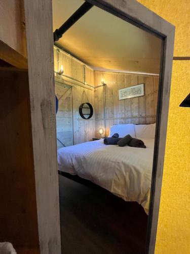 a bed in a room with a mirror at Aladdin Safari Tent in Tenby