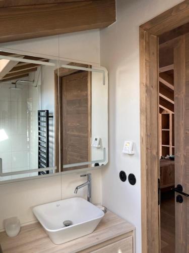 a bathroom with a sink and a mirror at LE 1307 in Megève