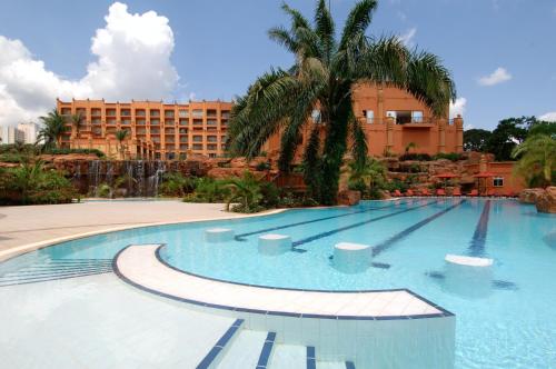 a large swimming pool in front of a hotel at Kampala Serena Hotel in Kampala