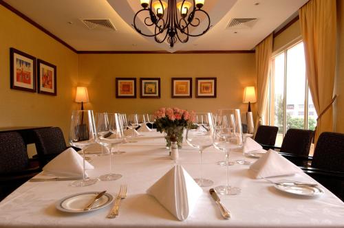 a long table with glasses and flowers in a room at Kampala Serena Hotel in Kampala