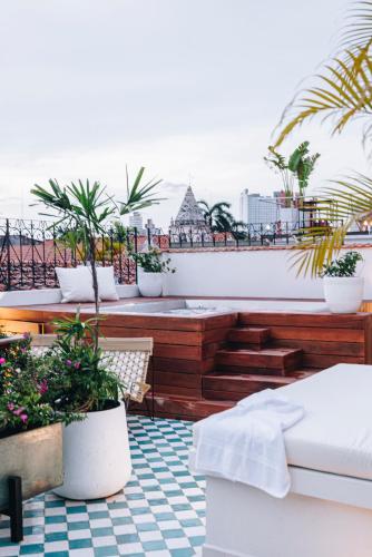 a balcony with potted plants on top of a building at Amarla Boutique Hotel Casco Viejo in Panama City