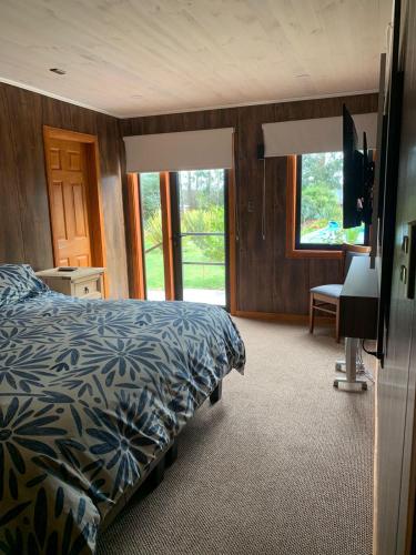 a bedroom with a bed and a television in it at Hotel Boutique Family Suites in Panguipulli