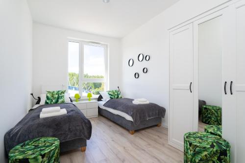 Ένα ή περισσότερα κρεβάτια σε δωμάτιο στο Symphony Modern Tower Apartamenty