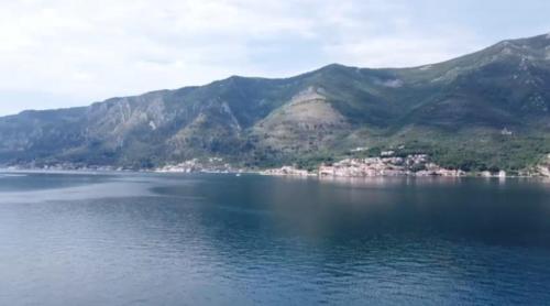a view of a large body of water with mountains at lovely apartment on the sea shore, with a view and free Wi-Fi in Kotor