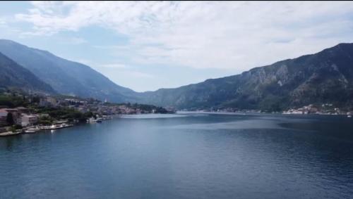 a large body of water with mountains in the background at lovely apartment on the sea shore, with a view and free Wi-Fi in Kotor