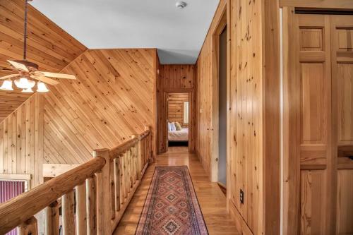 a hallway in a log cabin with wooden walls at Ischua Ridge Ellicottville Private Resort. Ski, Explore, Rest! in West Valley