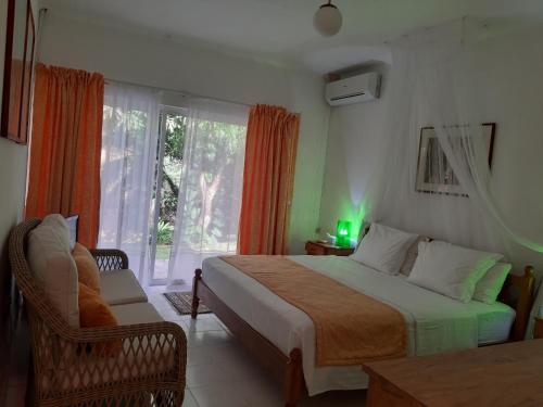 En eller flere senge i et værelse på Belombre River Villa