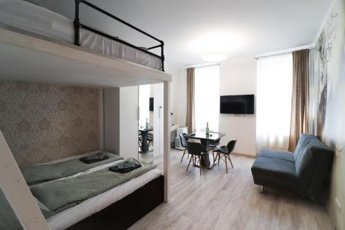 a bedroom with a bunk bed and a dining room at CozyNite Premium Apartment Favoriten 1 in Vienna