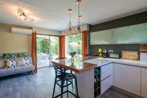 a kitchen with a island in the middle of a room at The Maryalice charming little house next to the beach! in Saint-Jorioz