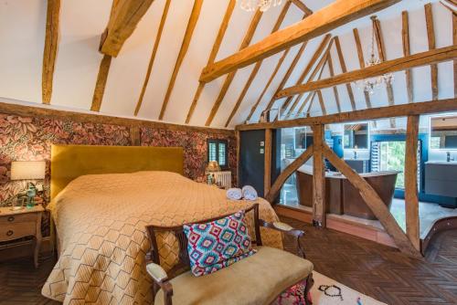 a bedroom with a bed in a room with wooden ceilings at Bacchus by Bloom Stays in Canterbury