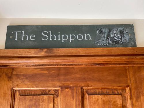 a chalkboard sign on top of a wooden door at Boujie Barn- Shippon in Waterfall