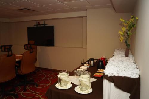 a conference room with two tables with glasses on them at Holiday Inn Tuxpan - Convention Center by IHG in Tuxpan de Rodríguez Cano