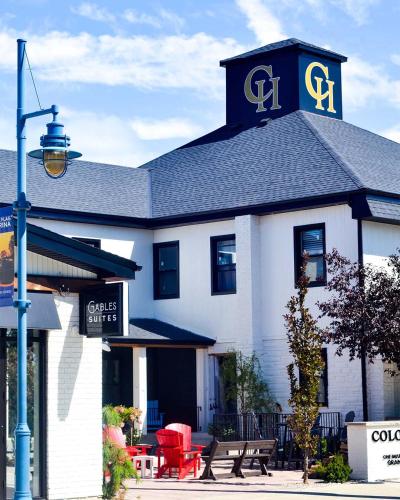 a building with a sign on the top of it at Colonial Hotel & Suites in Grand Bend