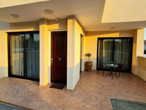 a front door of a house with yellow walls at PylaApts - Apartments near the beach in Pyla